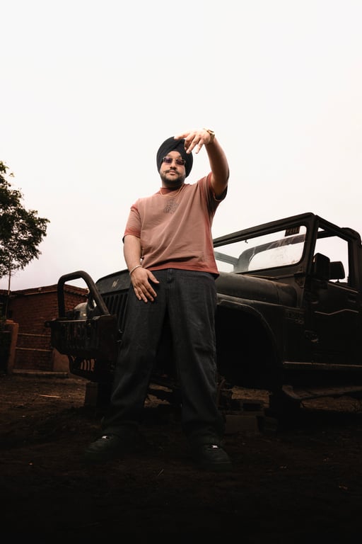 Wide portrait of Riar Saab beside the jeep