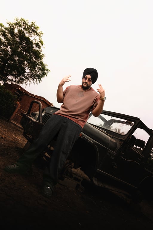 Riar Saab standing in front of a vintage jeep