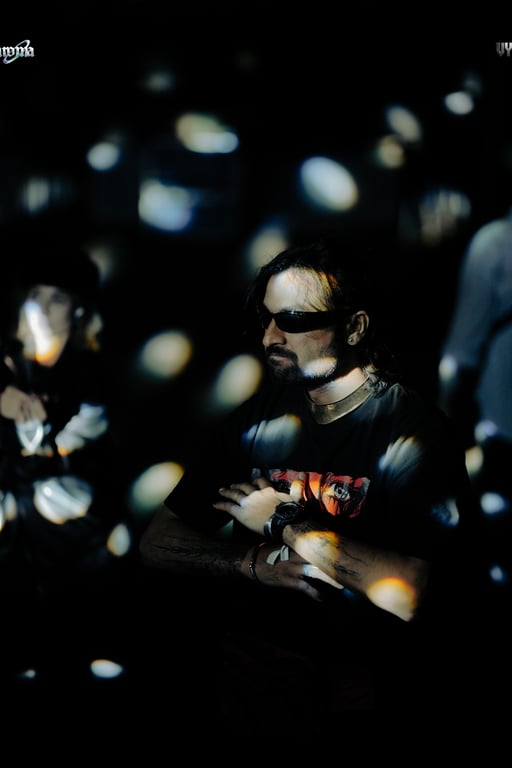 Silhouette of a DJ set against stage lighting