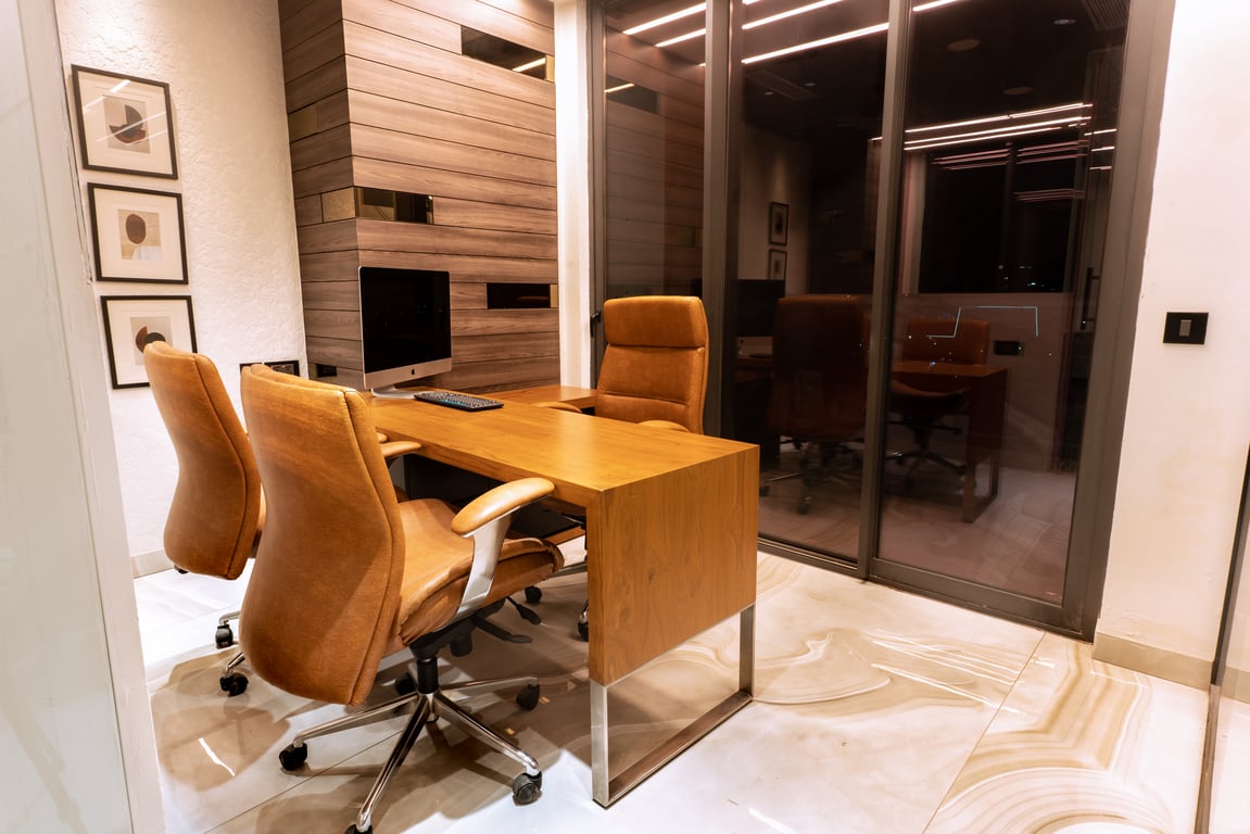 Executive office with desk and patterned wall light