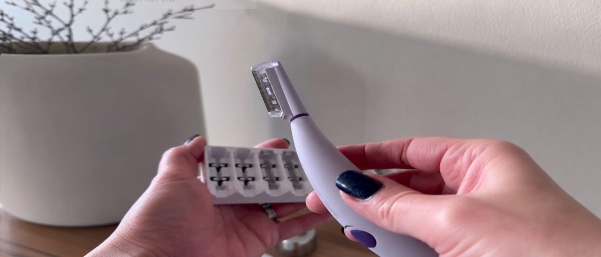 Hands holding the SonicSmooth Pro+ dermaplaning device