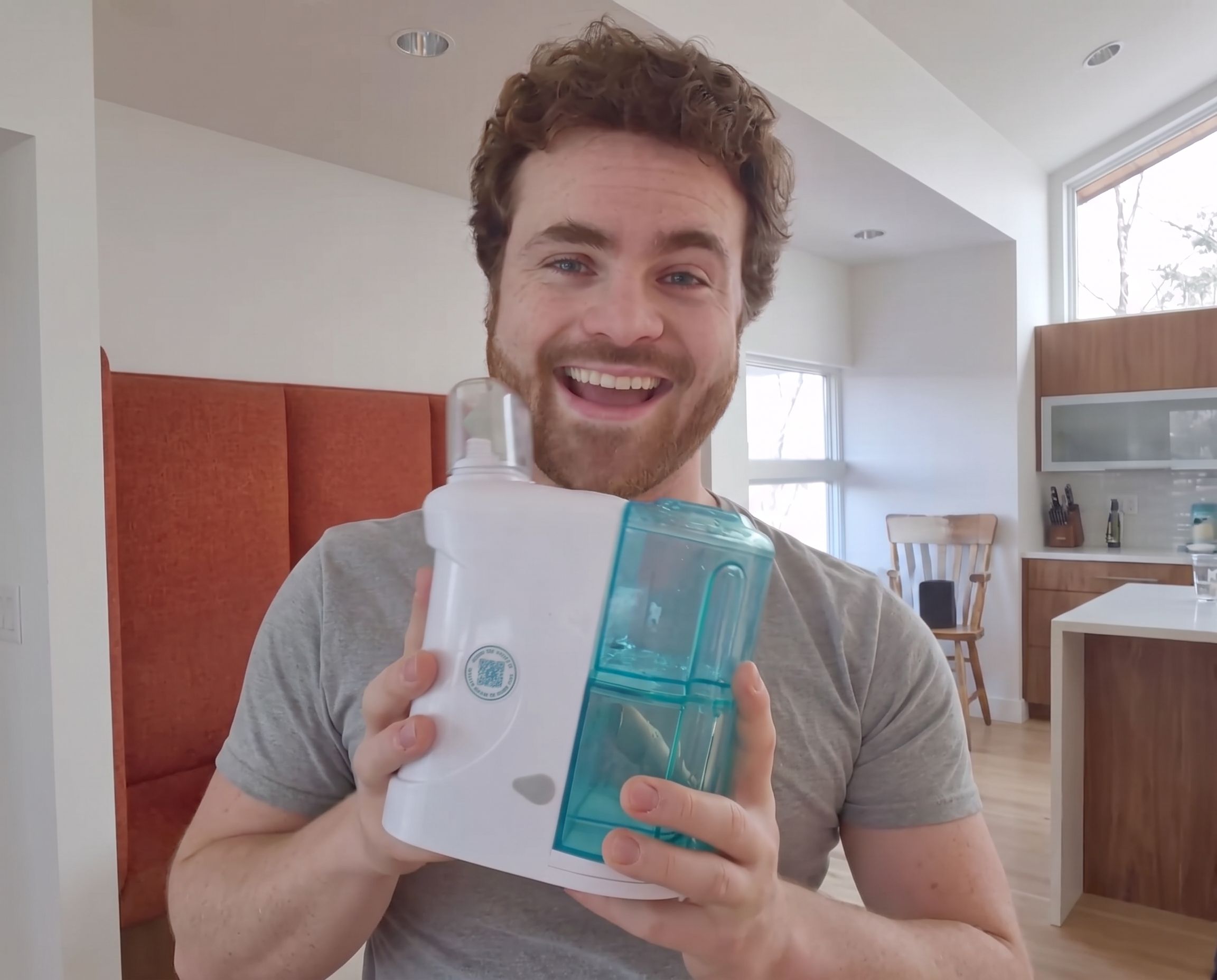 Smiling customer holding the NasalFresh MD device
