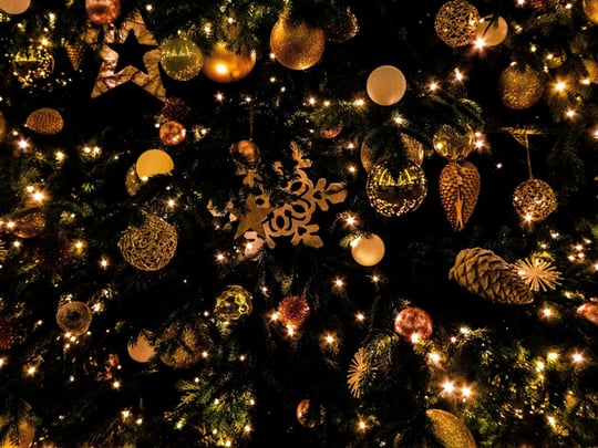 Christmas tree decorated with golden baubles and pinecones