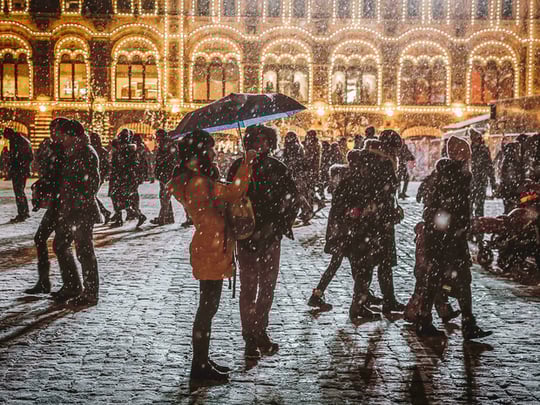 Busy and snowy cobbled street