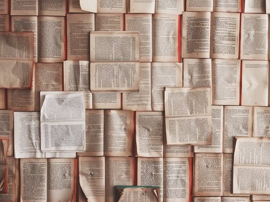 Many open books laid out together