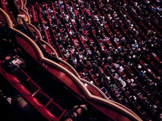 Audience sitting in a performance theatre