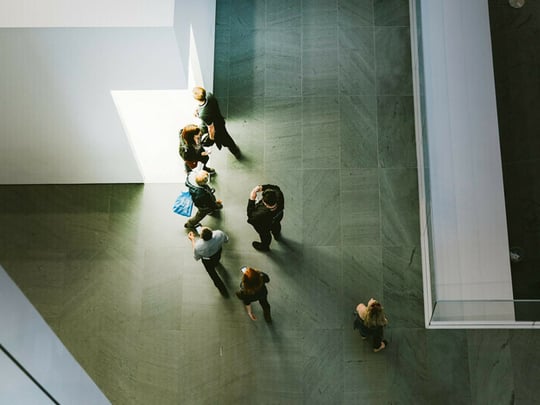 Top down view of people in grey space