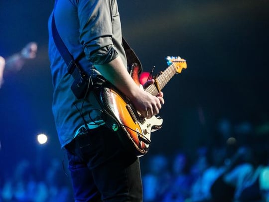 Guitarist playing to a large crowd