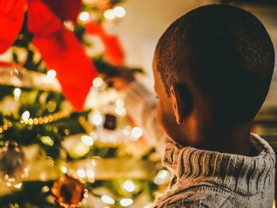 Small child close to Christmas tree