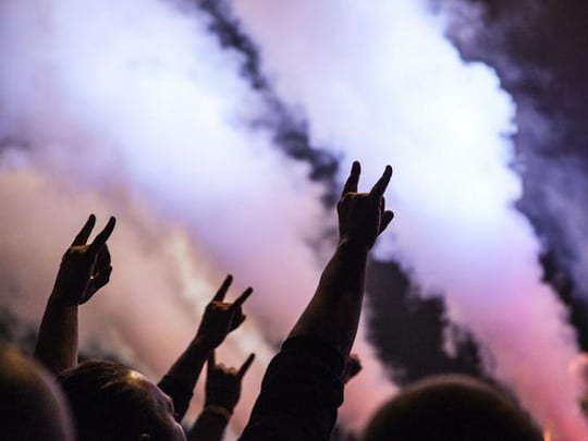 Hands in the air with pink and purple smoke