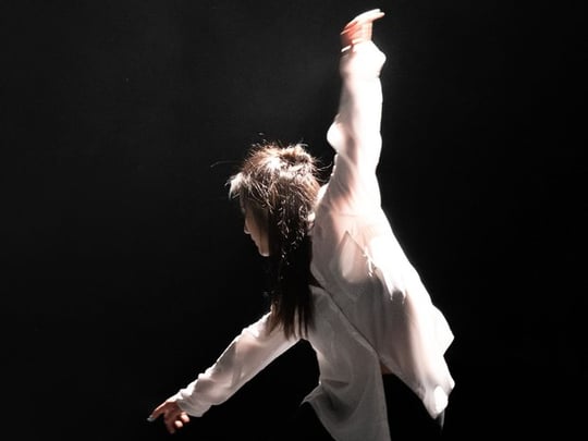 Person in casual wear dancing onstage