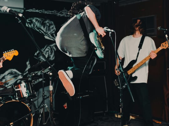 Guitarist jumping on stage