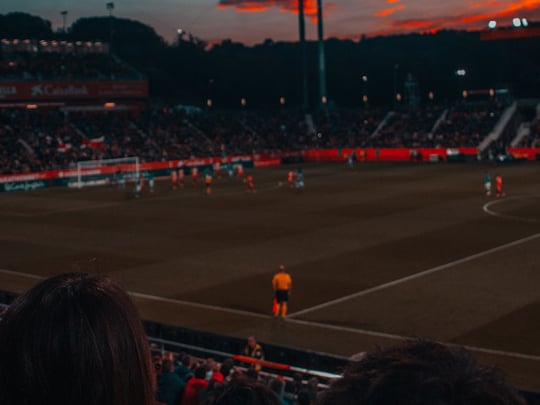 Football game at sunset in stadium