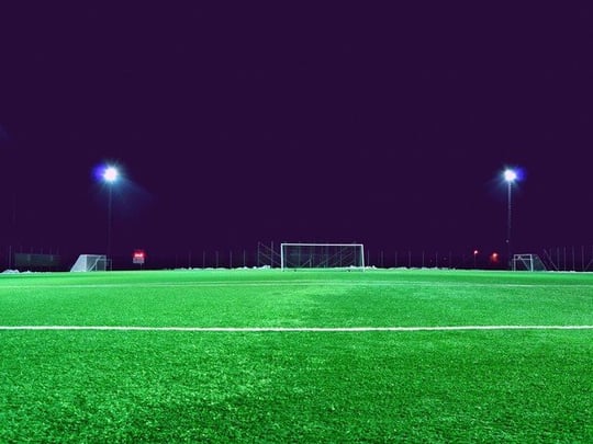 Empty football pitch at night with lights
