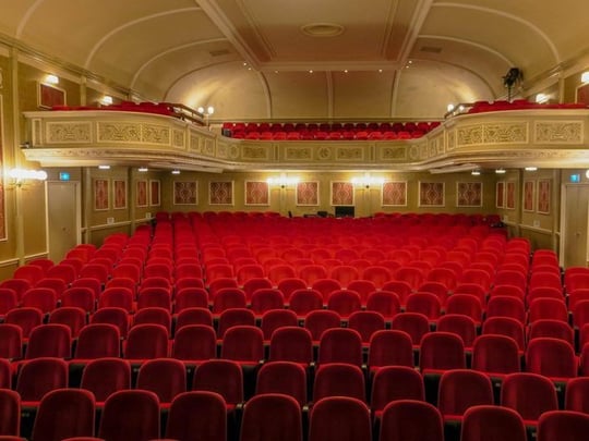 Empty red seats in a theatre