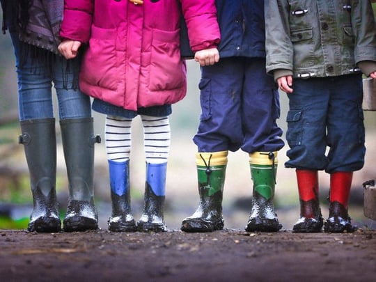 Four kids with muddy boots