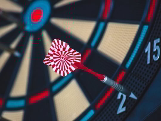 Red and white dart on dartboard