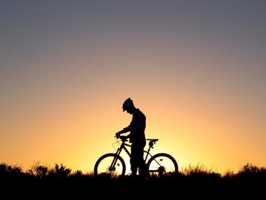Lone cyclist at sunset