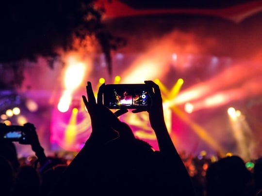 People at a concert taking pictures with phones