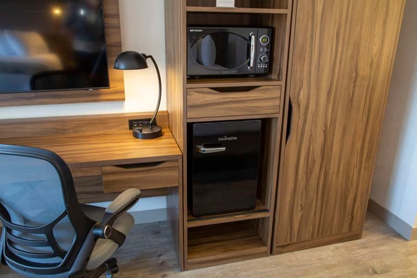 Deluxe Guest Rooms microwave and refrigerator