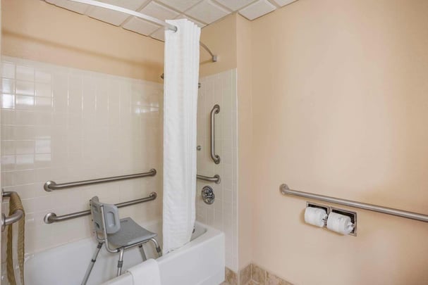 Accessible tub with grab bars and shower chair