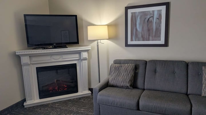 Queen Beds Sofa and Fireplace