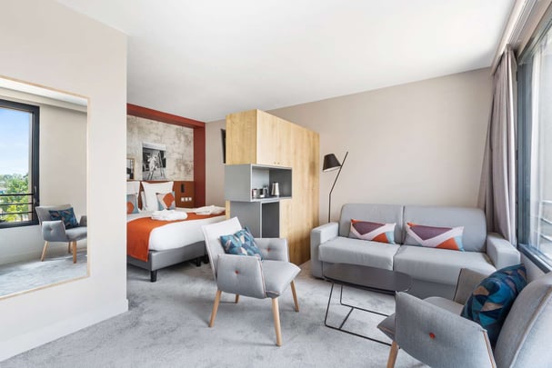 Family Guest Room with One Queen Size Bed and Double Sofabed in the Sitting Area