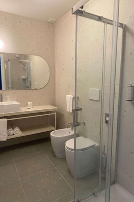 Bathroom in Guest Room with One Queen and One Twin Size Bed