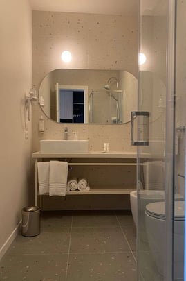 Bathroom in Guest Room with One Queen and One Twin Size Bed