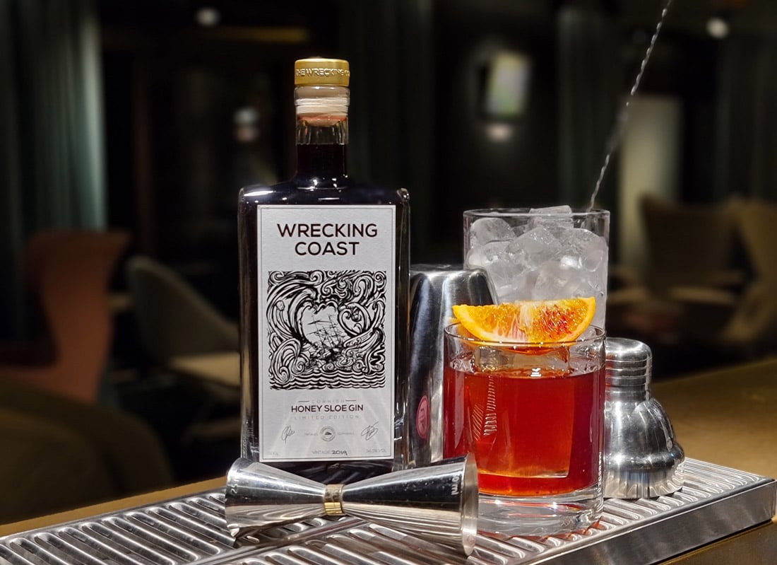 Honey sloe gin in cocktail on bar. Christmas spirits.
