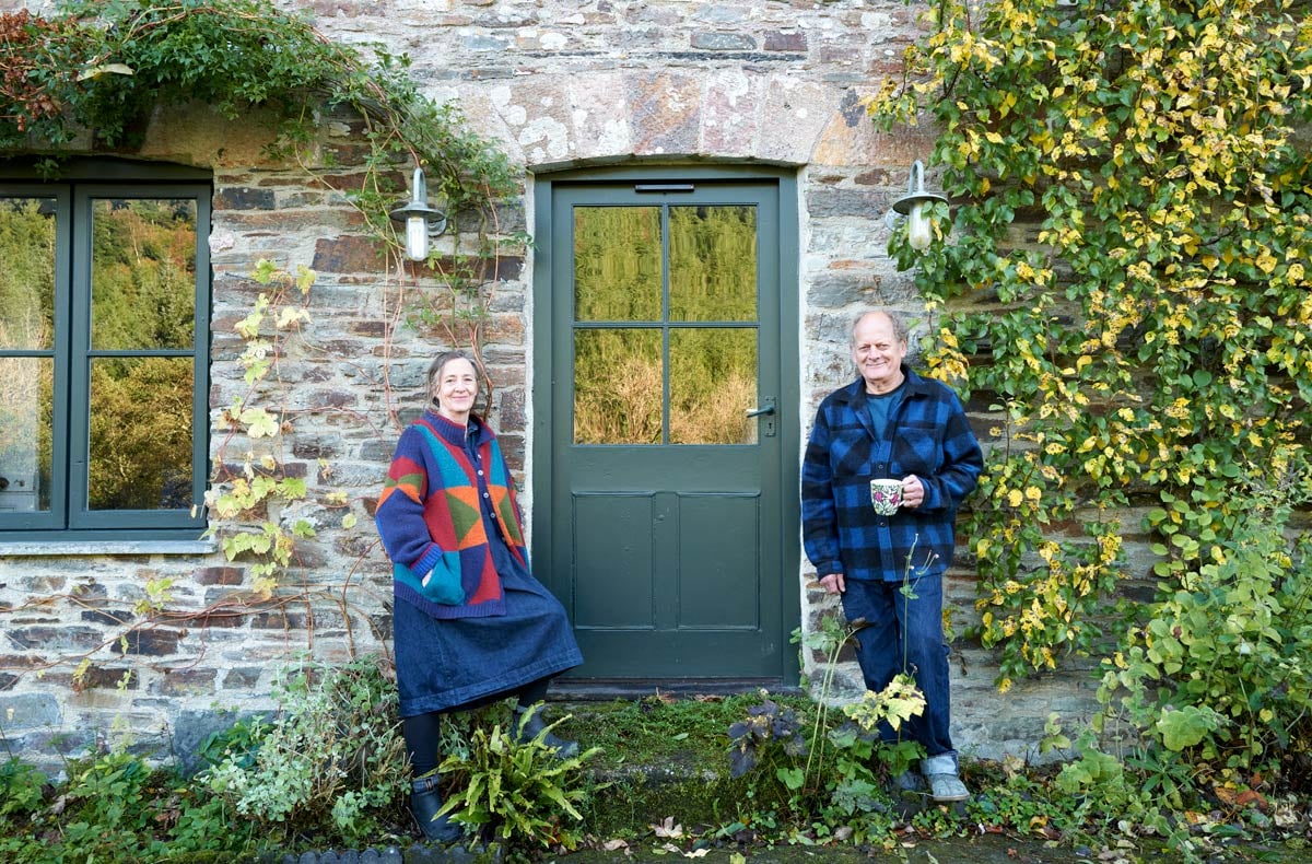 couple standing outside listed property fitted with cosyglazing