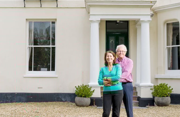 couple standing outside their period property