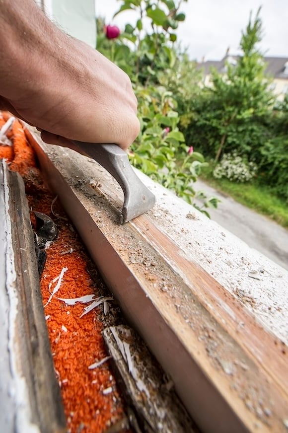 a craftsman filing a window frame