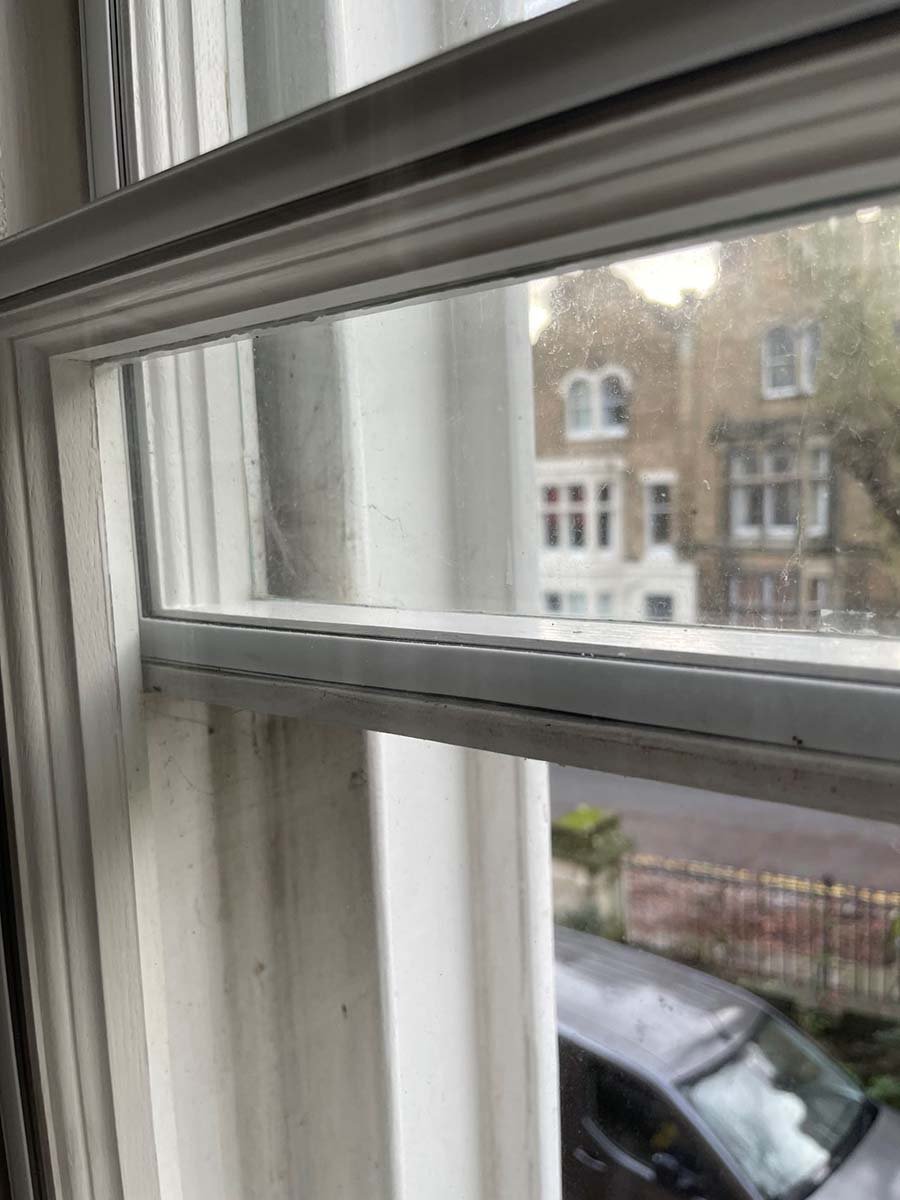 Sash window in listed building fitted with invisible secondary glazing