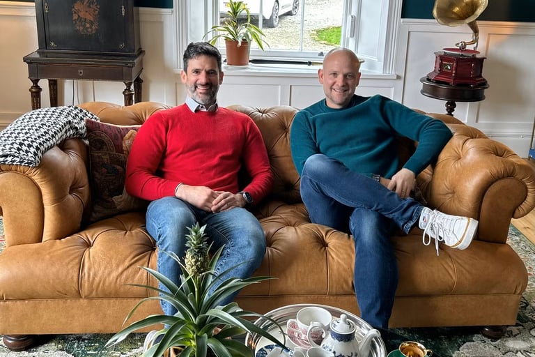 Owners on Sancreed House, Pablo and Grove sat on a sofa at property with CozyGlazing