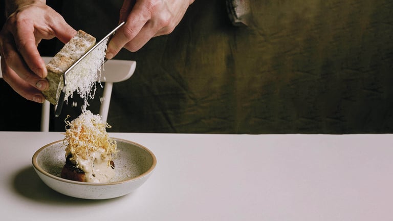 hands grating cheese at circa restaurant in totnes