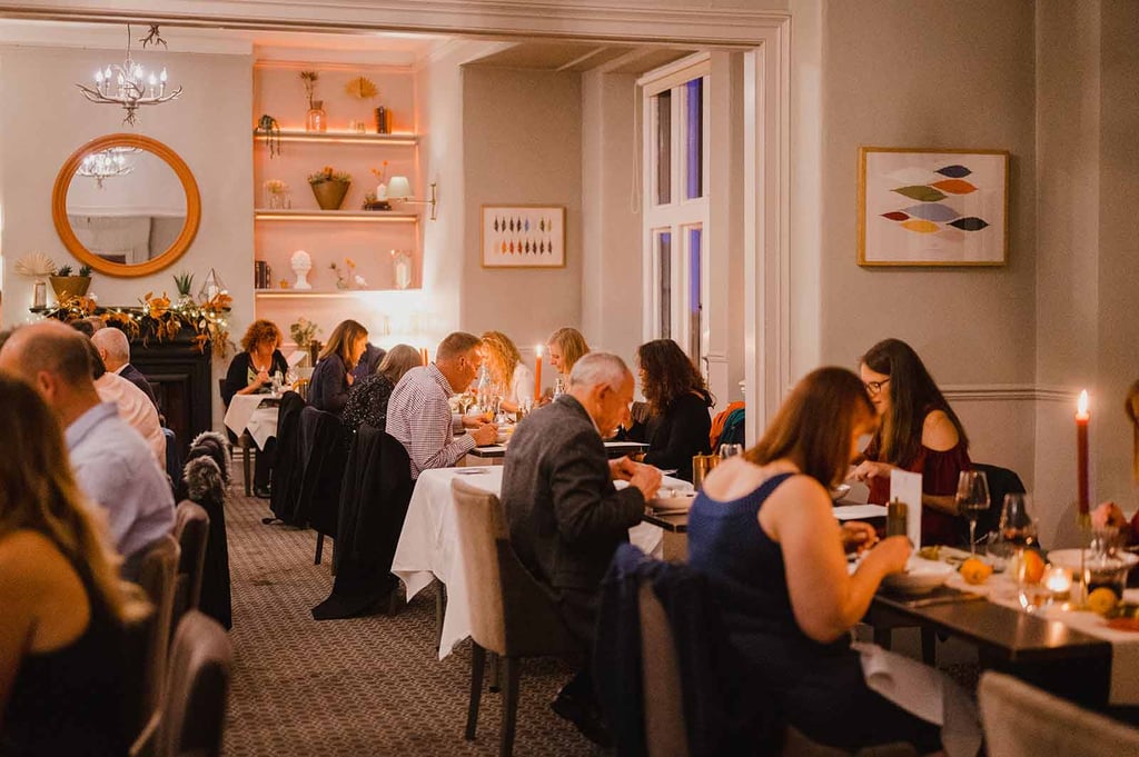 people eating food in the restaurant at the alverton hotel in truro