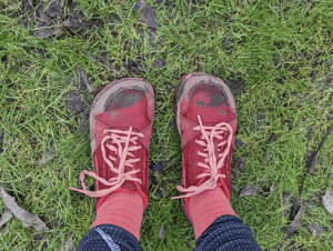 A pair of battered and muddy shoes at the end of a Half Marathon