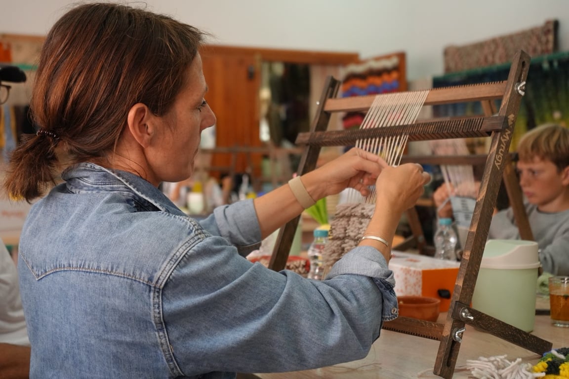 Couple selecting wool colors in a Marrakech weaving workshop.