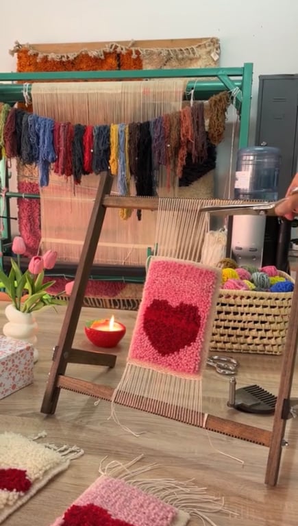 Couple weaving together on a loom in Marrakech; intimate moment.