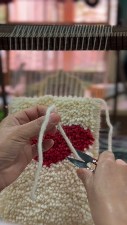 Traditional rug weaving tools: loom, comb, scissors, shuttle, wool.