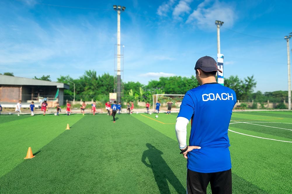 blurred image of Coach is coaching Children Training In Soccer Team