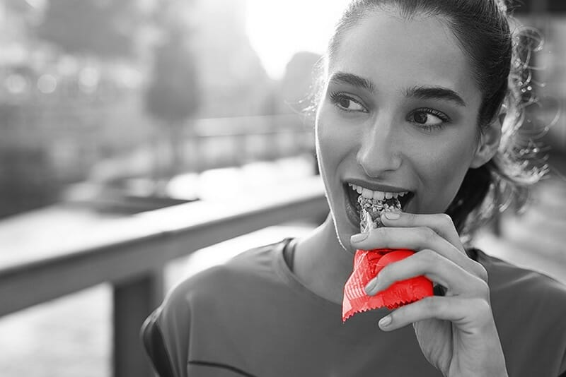 Woman Eating a Protein Bar