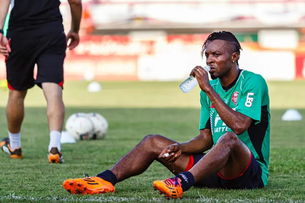 Football Sat on Pitch Drinking Water