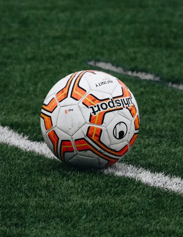 Orange Football on Dark Grass
