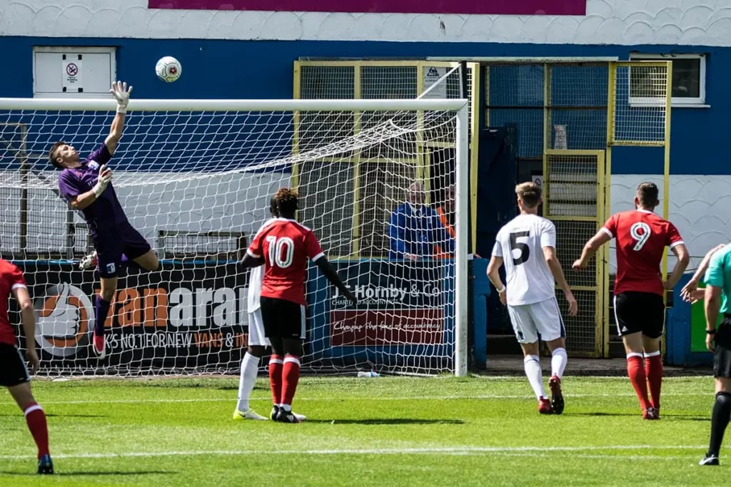 Goalkeeper jumping to make a save