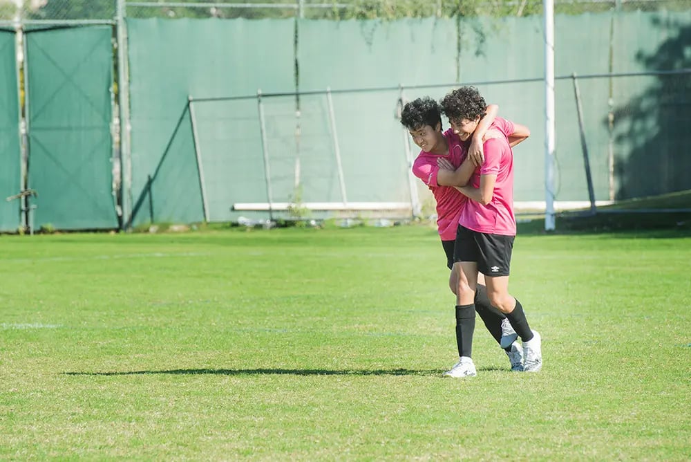 two young female footballers celebrating