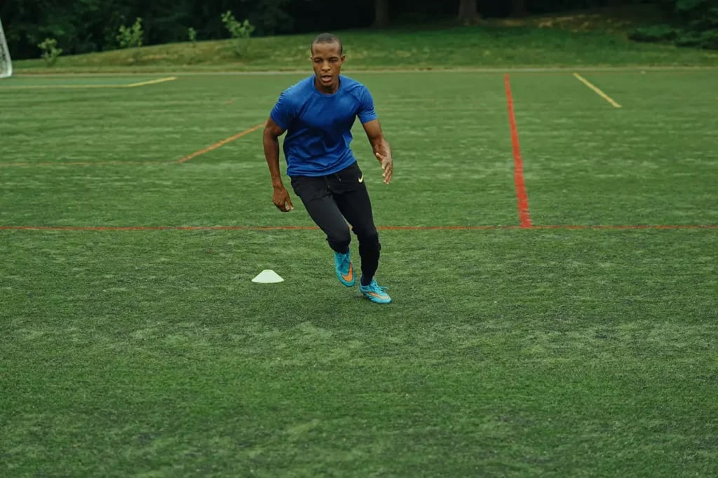 a man doing exercise training on a football field