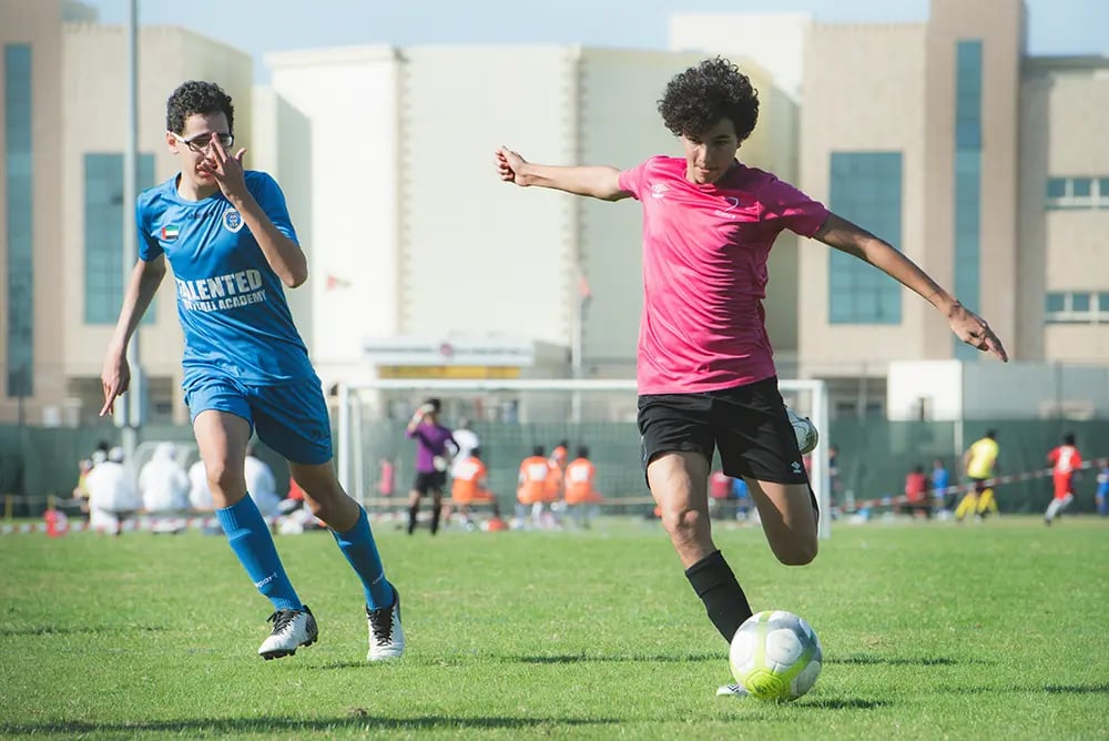 teenage boys playing football