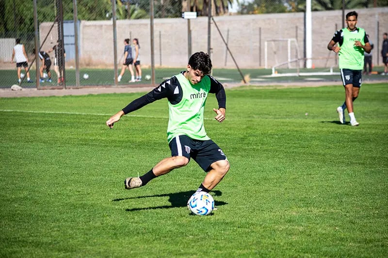 Soccer player training kicking a ball